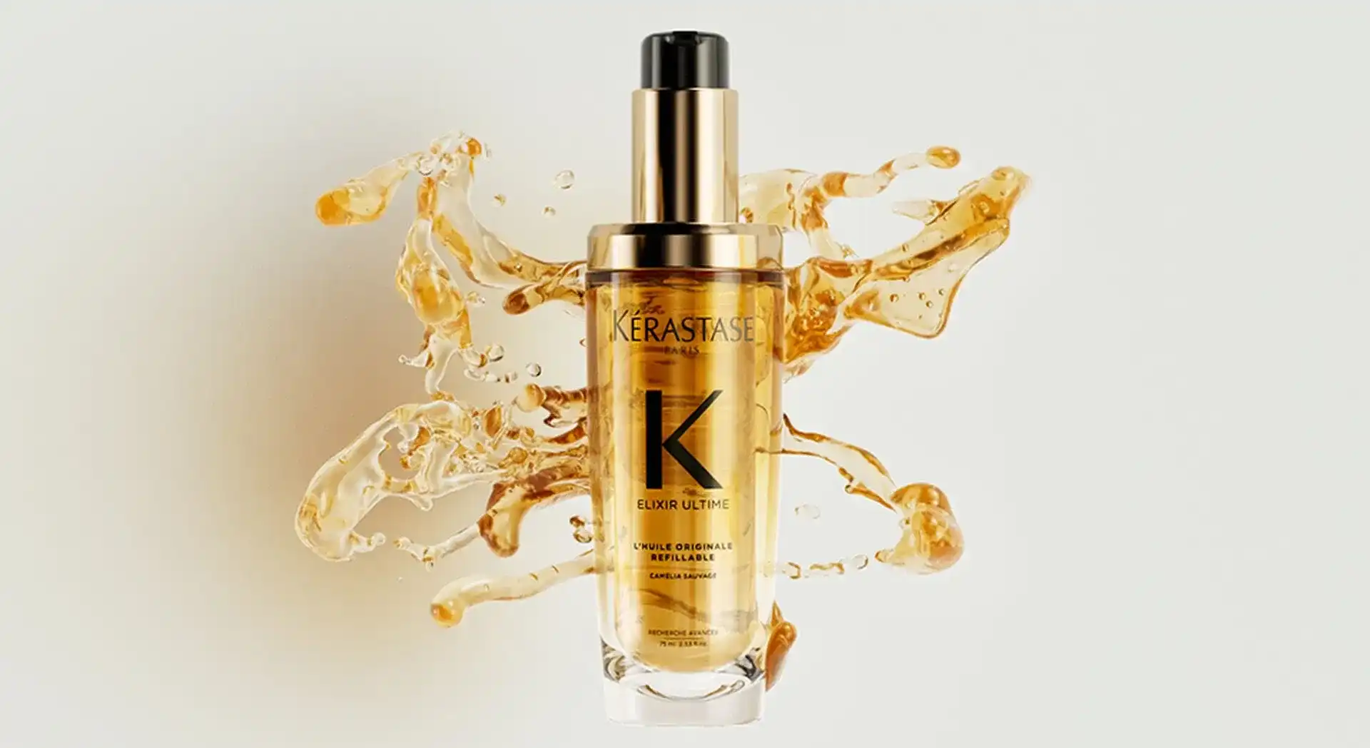 Kerastase Elixir Ultime bottle with splashes of oil around it.