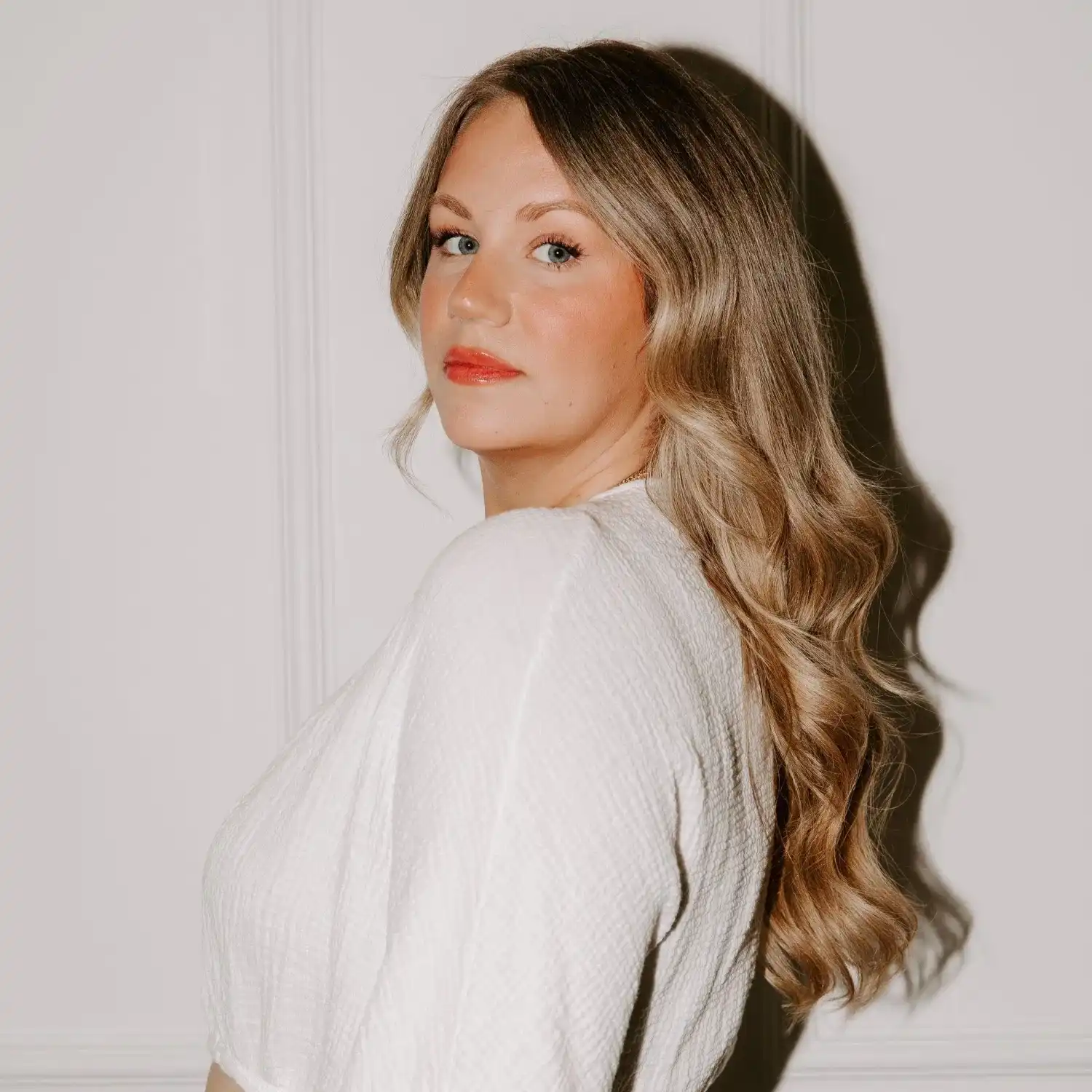 Portrait of Shelby, a professional stylist at Solo Salon, showcasing their expertise and style.